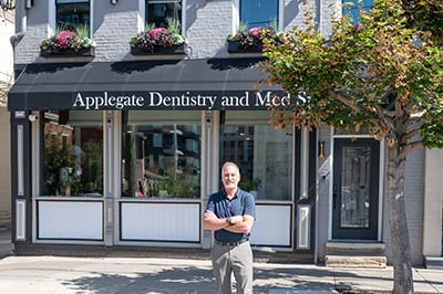 Dr. Barry Applegate standing outside of Applegate Dentistry & MedSpa building